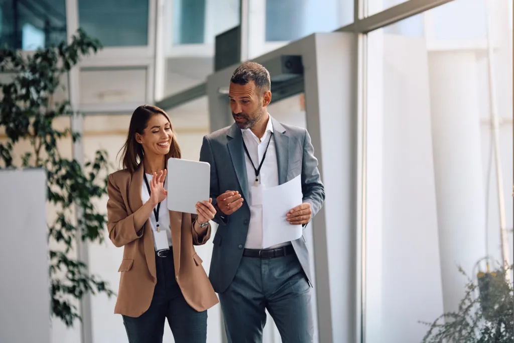 Happy,Businesswoman,And,Her,Colleagues,Working,On,Touchpad,In,The Happy,Businesswoman,And,Her,Colleagues,Working,On,Touchpad,In,The